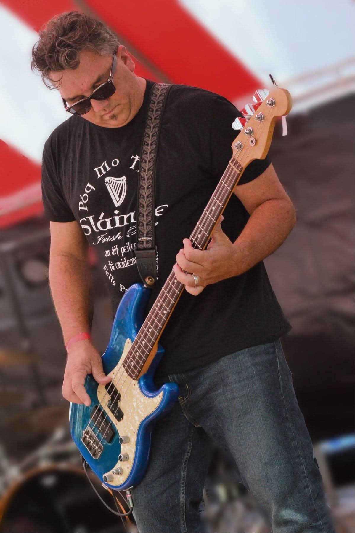 Judge Scott Warner playing bass guitar on stage